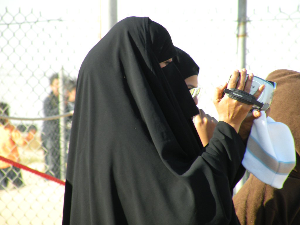a burqa weared woman taking video