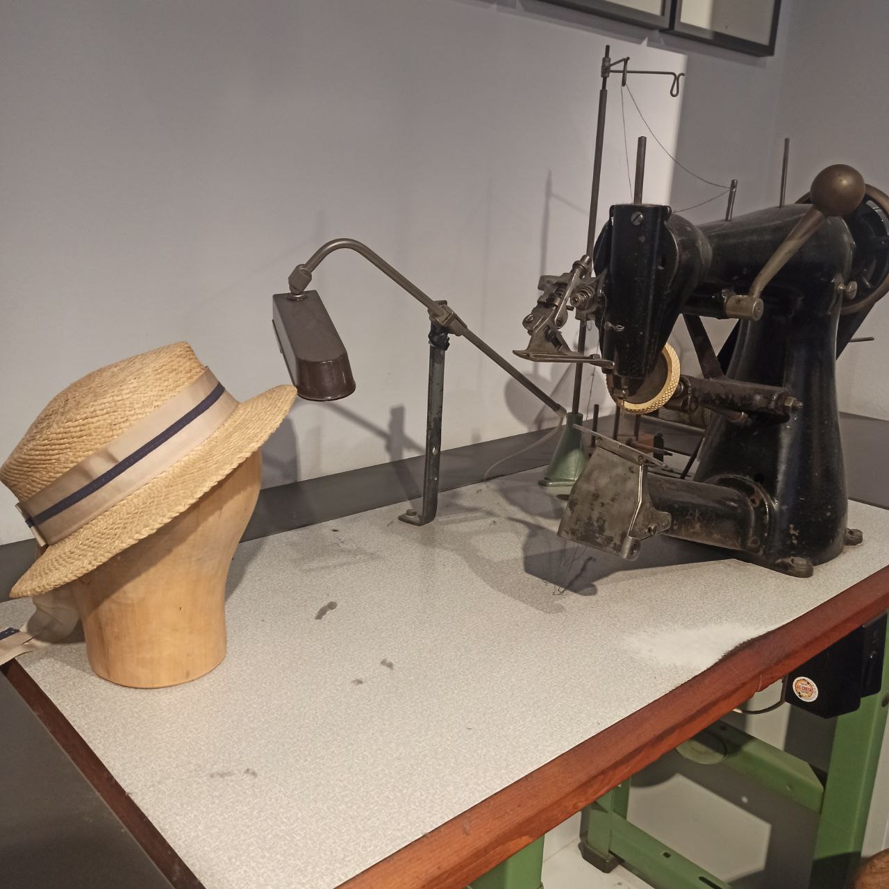 The one in the museum is a very old sewing machine designed for hat making. It was probably made in the 1800s.